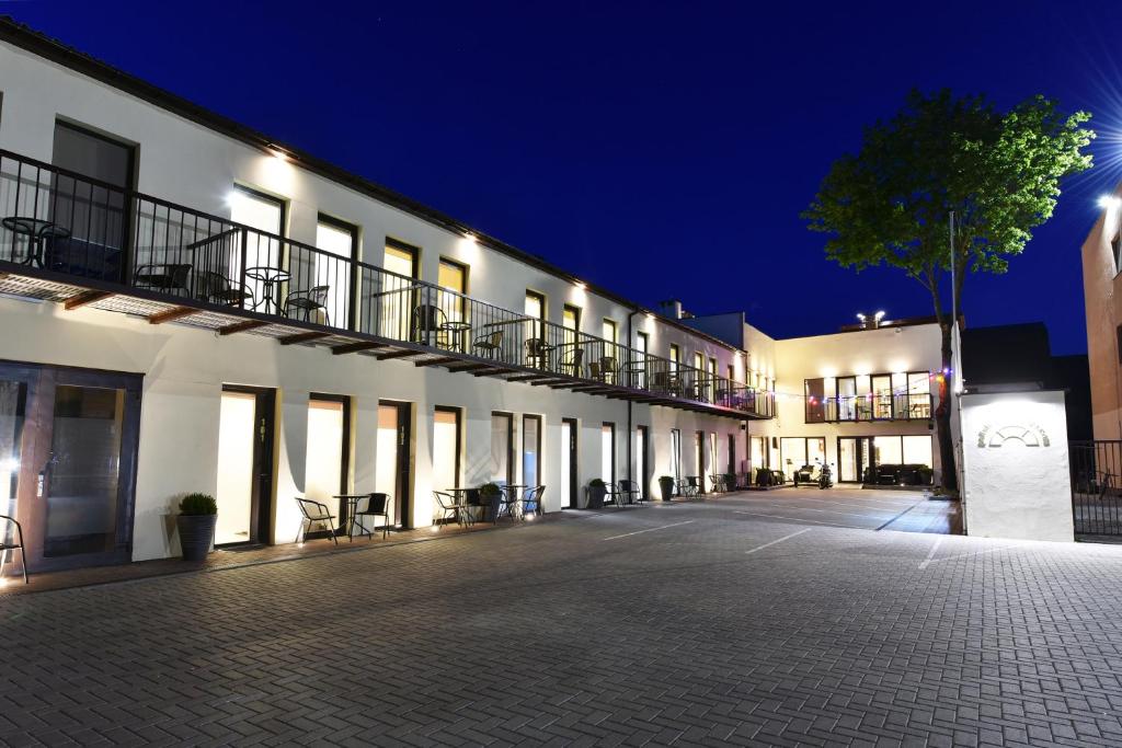 an empty courtyard of a building at night at Poilsis Palangoje in Palanga
