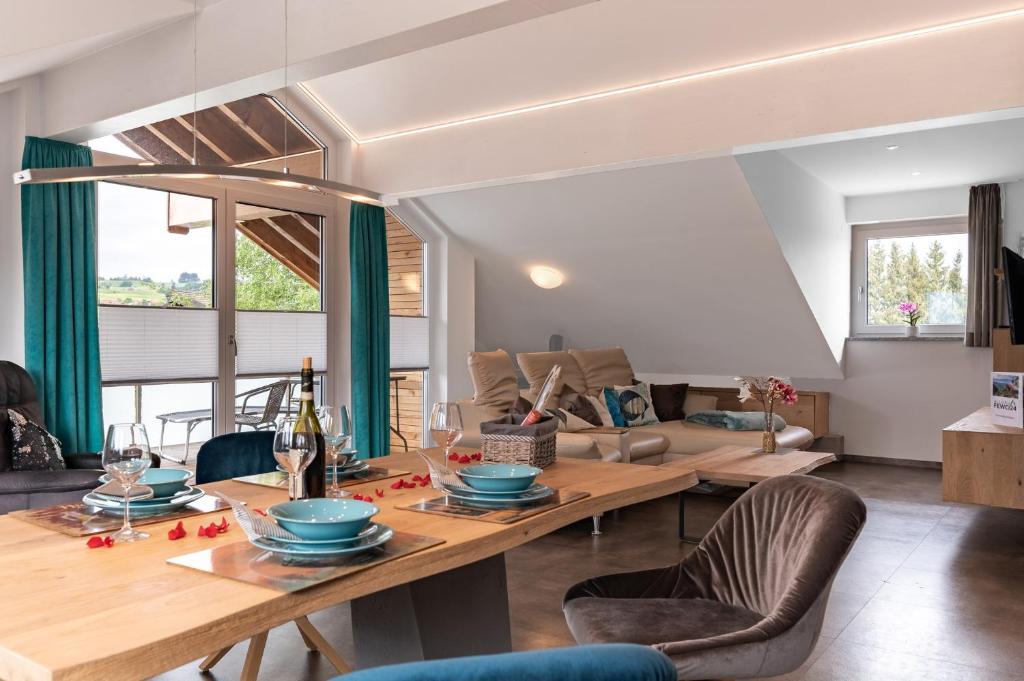 a living room with a table and a couch at Grünten-Chalet in Oy-Mittelberg