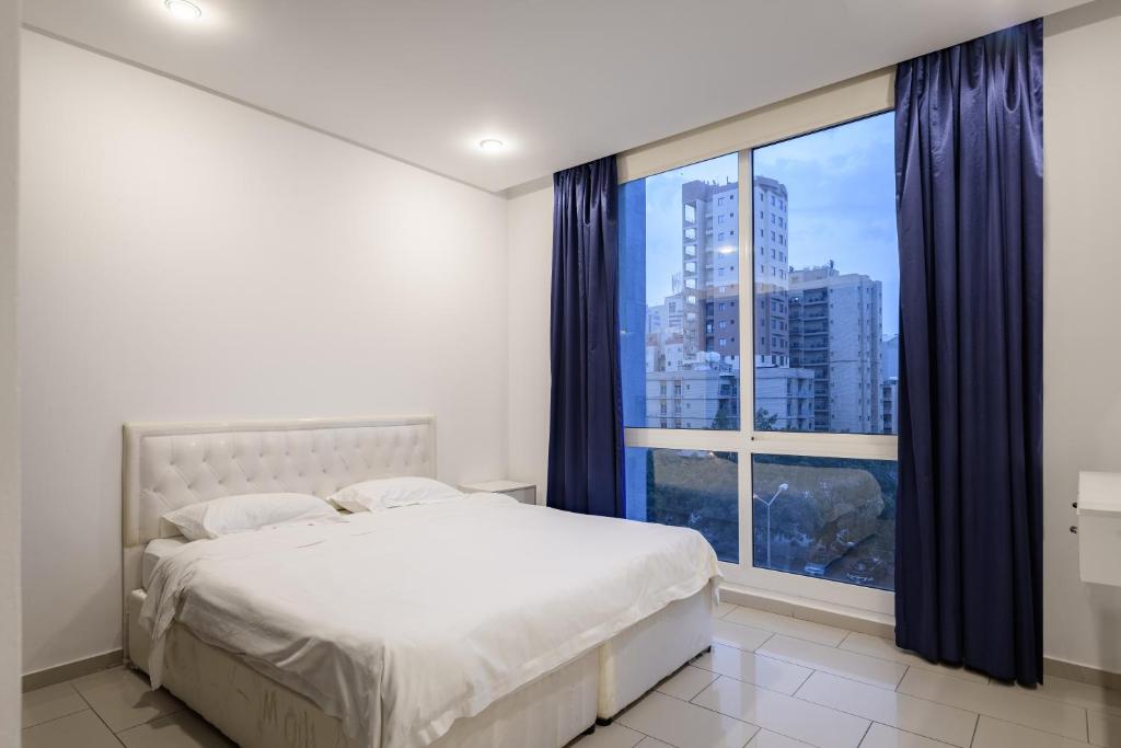 a bedroom with a bed and a large window at Code Housing - Salmiya-Family only in Kuwait