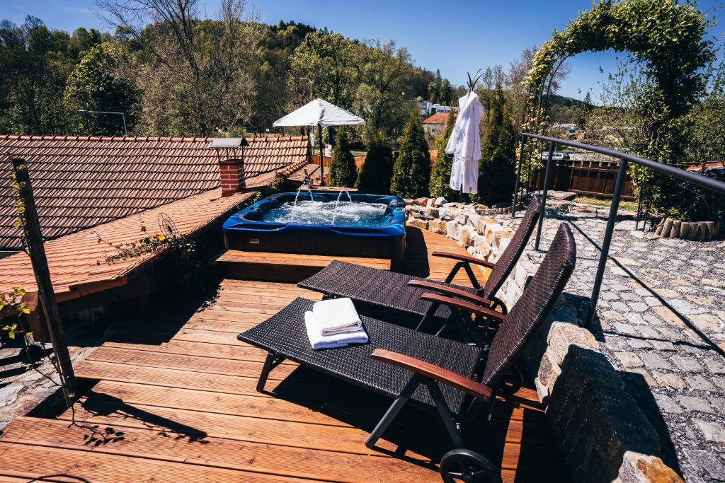a wooden deck with a bench and a swimming pool at Pension Fialka in Český Krumlov
