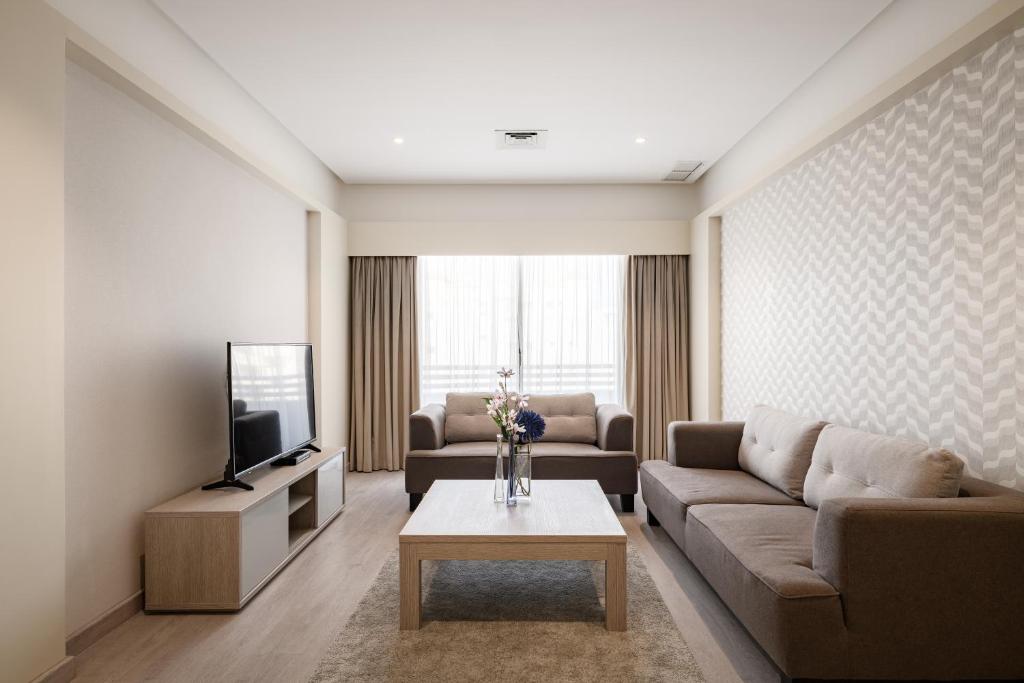 a living room with a couch and a tv at salmiya - Amman -Family only in Kuwait