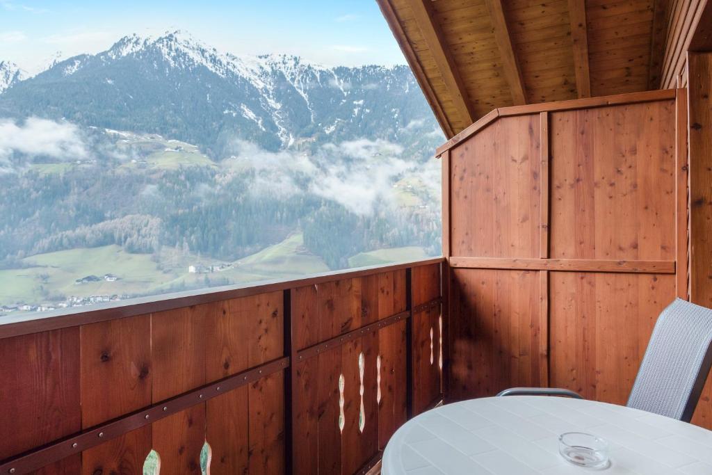 a room with a table and a view of a mountain at Hofschenke Pfeiftal - Bergwiese in San Martino