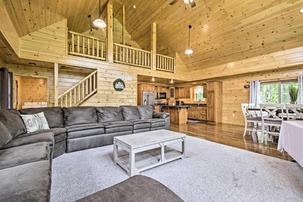 a living room with a couch and a table at Lake View and Hot Tub Wrightsville Cabin! in Wrightsville