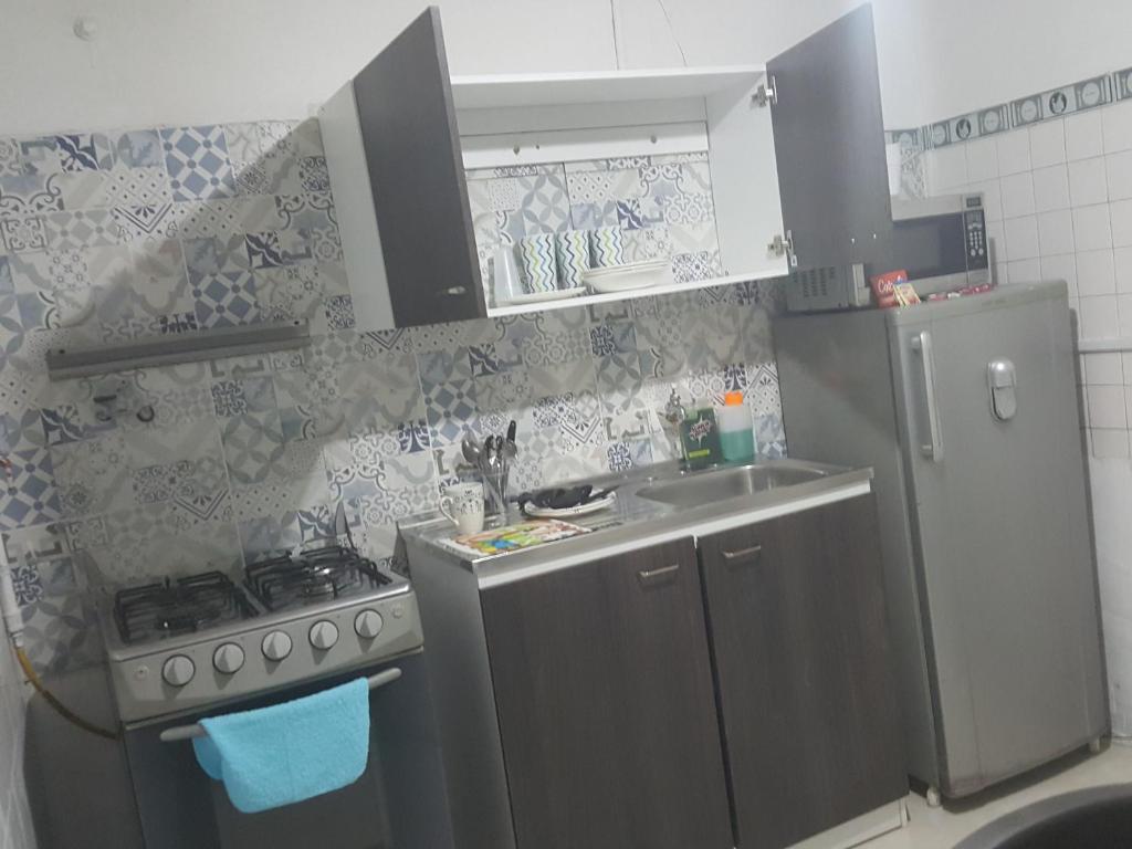 a small kitchen with a sink and a refrigerator at Cerca al club militar embajada americana, Corferias 502 in Bogotá