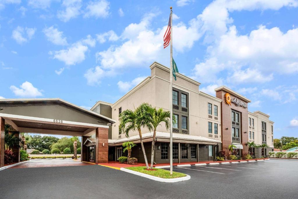 a hotel with an american flag on top of it at La Quinta by Wyndham St. Petersburg Northeast *Newly Renovated in St Petersburg