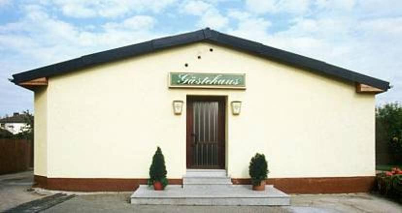 a white building with a sign on top of it at Oranienblick in Gückingen