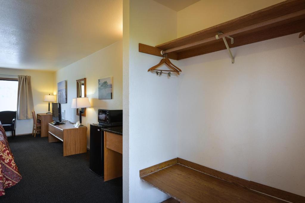 a hotel room with a bed and a living room at Cap Sante Inn in Anacortes
