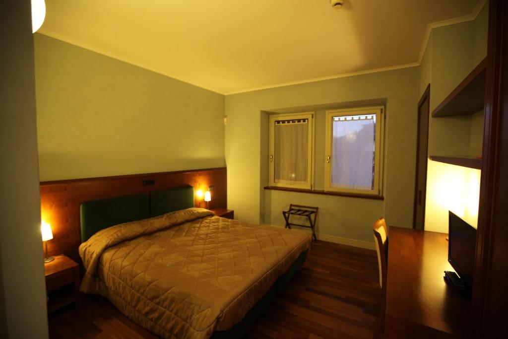 Postel nebo postele na pokoji v ubytování Hotel Rosa