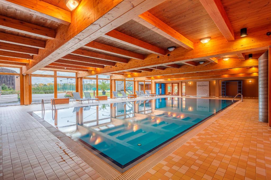 a large indoor swimming pool in a building at Park Holiday Congress & Wellness Hotel in Prague