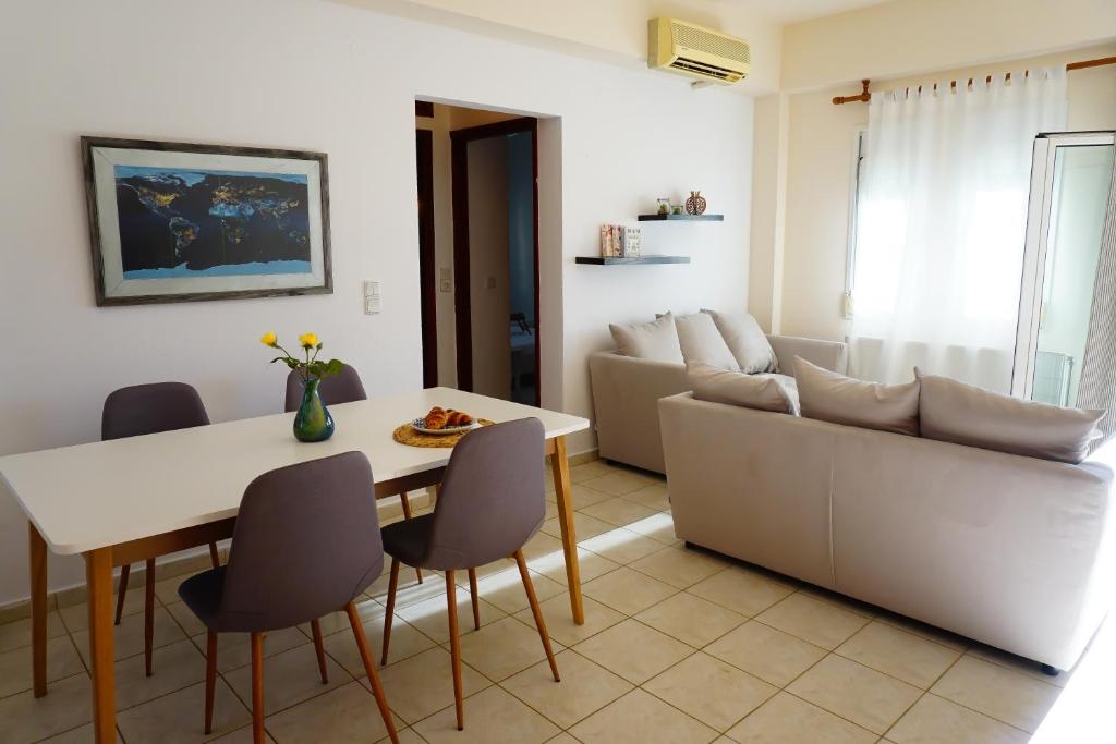 a living room with a table and a couch at Nectar Apartments in Istro