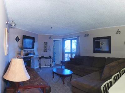 a living room with a couch and a table at Winterplace Condos - Ski in Ski out E104 in Ghent