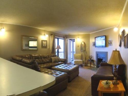 a living room with a couch and a table at Winterplace Ski in Ski out condo First Floor D103 in Ghent
