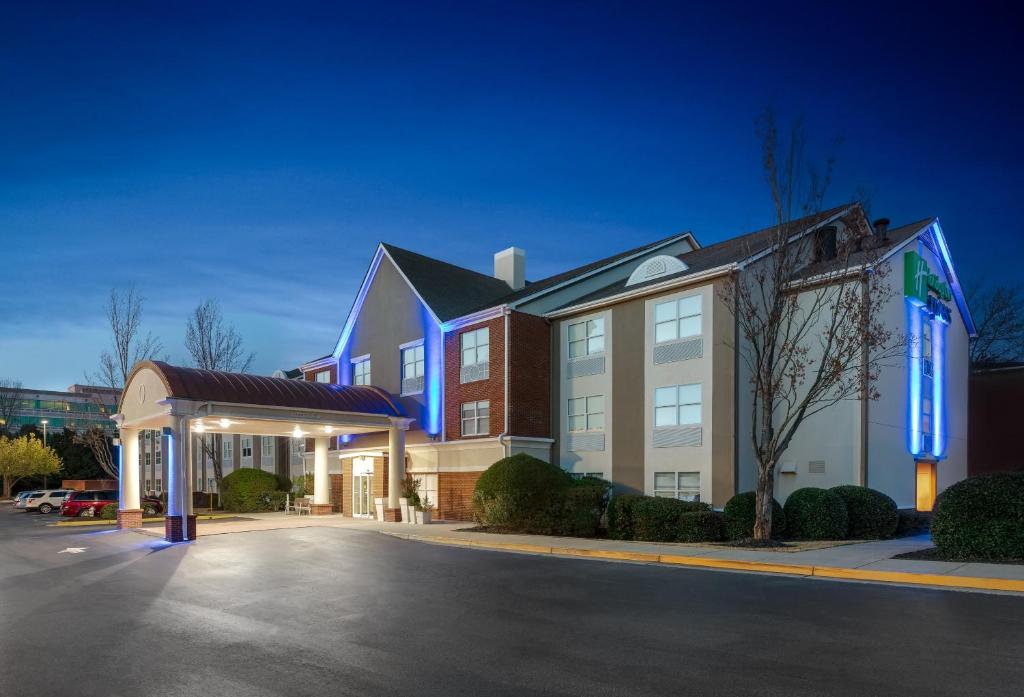 a hotel with a parking lot in front of a building at Holiday Inn Express Alpharetta - Roswell, an IHG Hotel in Alpharetta