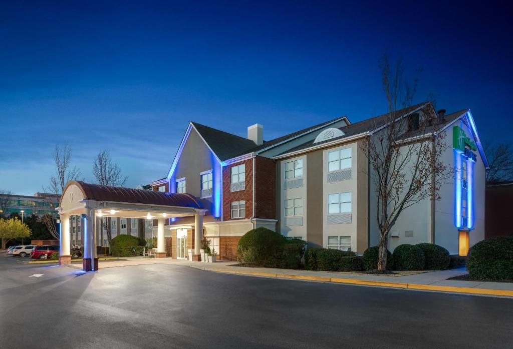 a hotel with a parking lot in front of a building at Holiday Inn Express Alpharetta - Roswell by IHG in Alpharetta