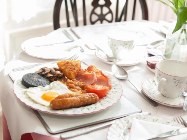 a plate of breakfast food on a table at The Heidi Bed & Breakfast in Southport