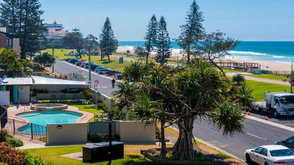 a view of a road and a beach and a building at Sandrift Beachfront Apartments in Gold Coast