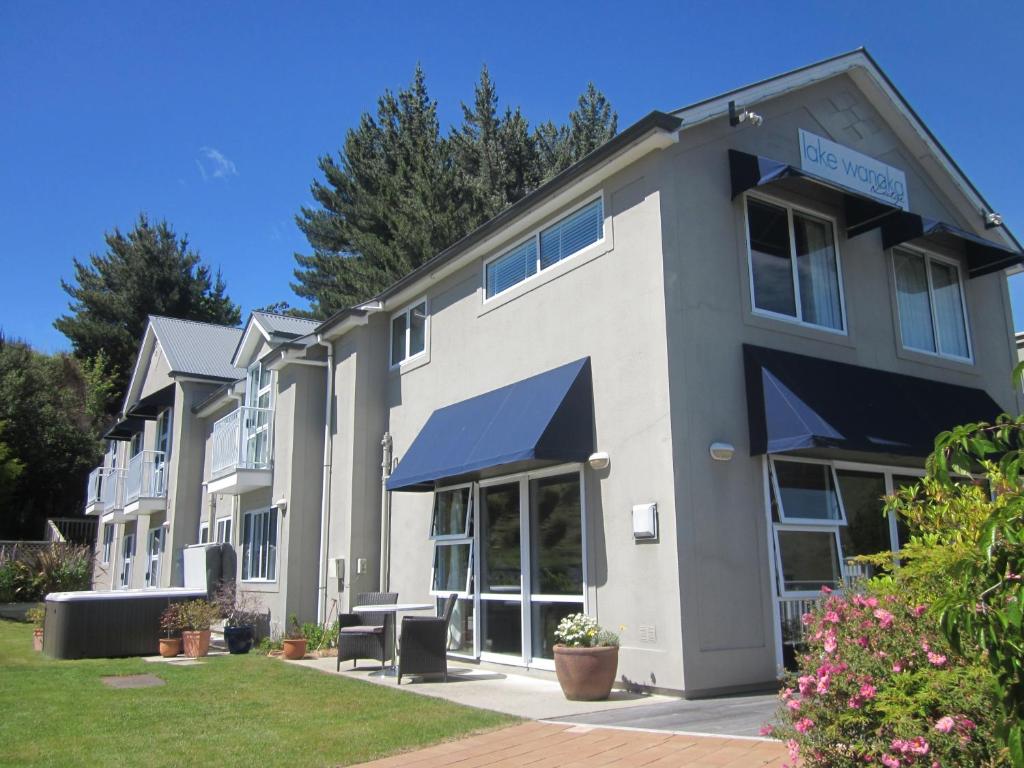 a building with blue awnings on the side of it at Lake Wanaka Lodge in Wanaka