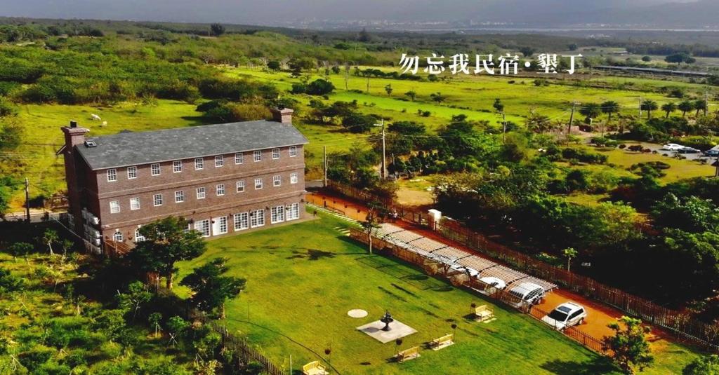 an aerial view of a building with a train in a field at 墾丁勿忘我城堡莊園 in Hengchun