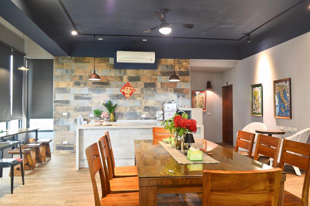 a kitchen and dining room with a table and chairs at 1969 Meters Square Seed B&B in Jian