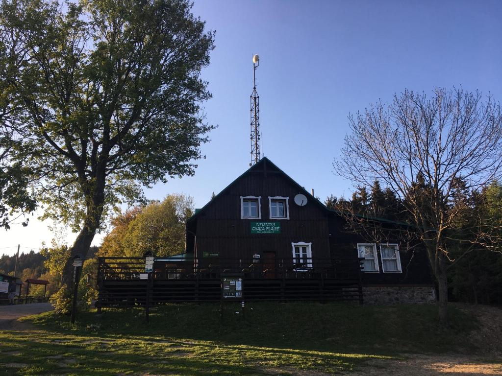 a black barn with a tower on top of it at Turistická Chata Pláně in Český Dub