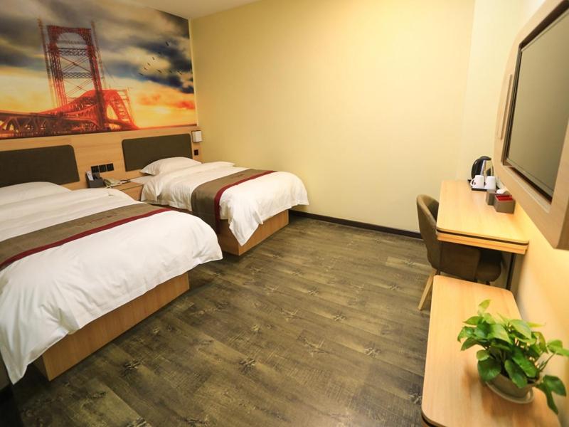 a hotel room with two beds and a desk and a tv at Thank Inn Plus Hotel Langfang Bazhou Shengfang Bus Station in Langfang