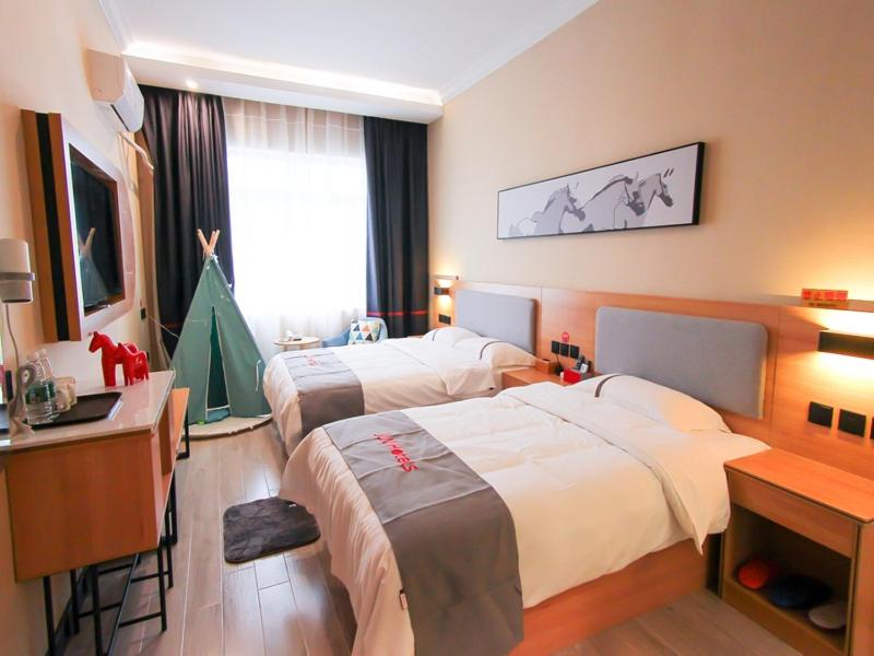 Voodi või voodid majutusasutuse JUN Hotels Gangxi Nanning Wuming Xiangshan Avenue toas