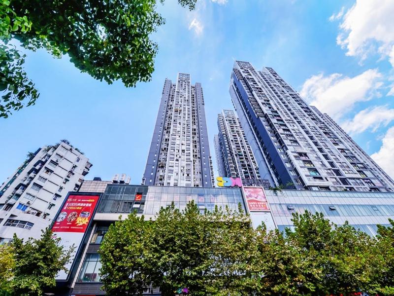 two tall buildings in a city with trees at JUN Hotels Chongqing Nan'an Nanping Dongmo in Chongqing