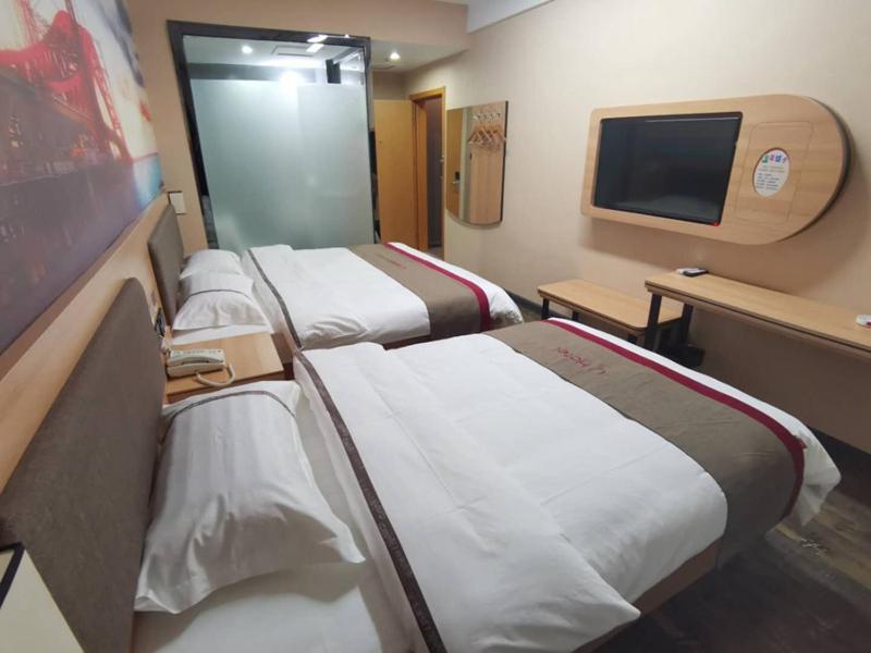 a hospital room with three beds and a flat screen tv at Thank Inn Chain Hotel Hohhot Xincheng District Xinhua Plaza in Hohhot
