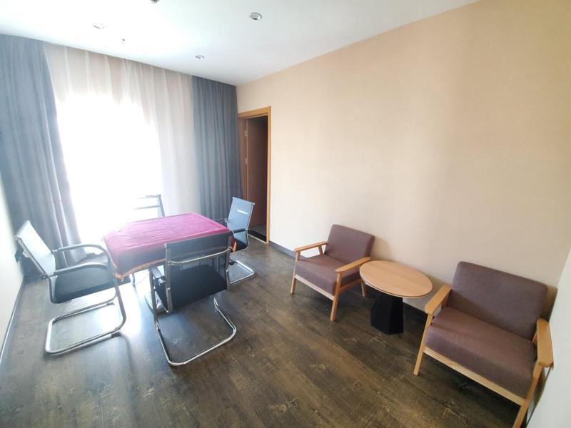 a room with a table and chairs and a table and a table and chairs at Thank Inn Chain Hotel Taiyang Yingze District Xiyang City Market City Hall in Taiyuan