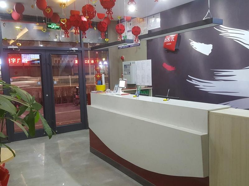 a restaurant with a counter in a room with red decorations at Thank Inn Chain Hotel Shandong Dezhou Jiefang South Avenue Store in Dezhou