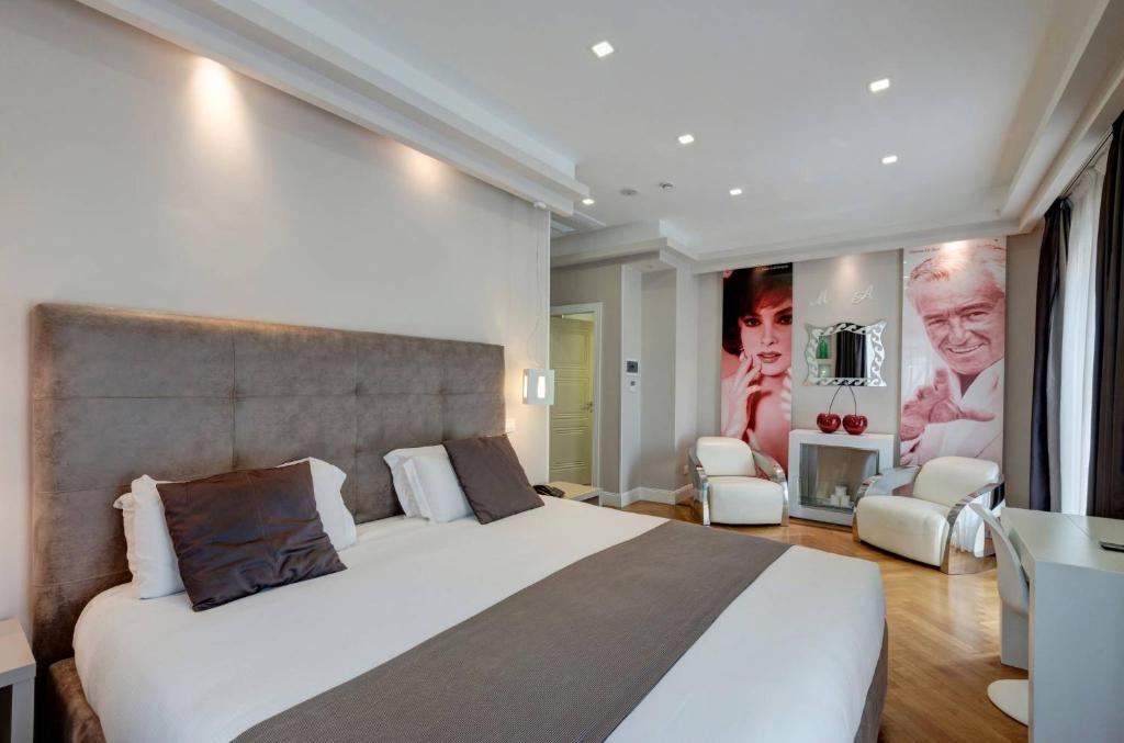 sypialnia z dużym białym łóżkiem i krzesłami w obiekcie Terrazza Marco Antonio Luxury Suite w Rzymie