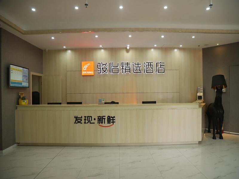 a lobby with a reception counter in a building at JUN Hotels Jiangnan Nanchang Nanchang County Xiaolan Industrial Park in Nanchang