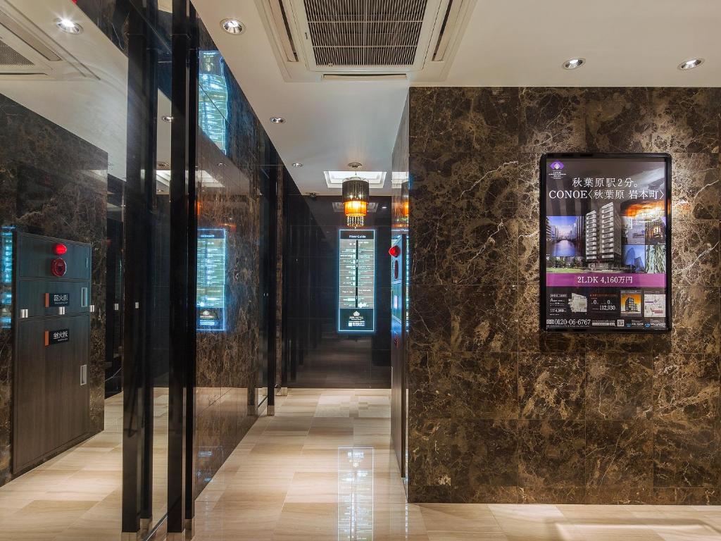 a hallway in a building with a sign on a wall at APA Hotel Akihabara Ekimae in Tokyo