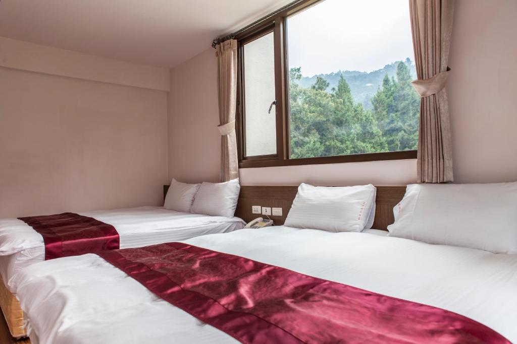 Postel nebo postele na pokoji v ubytování Sin Ging Hong Resort