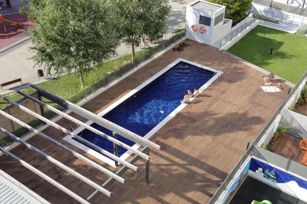 an overhead view of a swimming pool on a wooden deck at 1217 - POOL AND BEACH NICE APARTMENT II in Barcelona