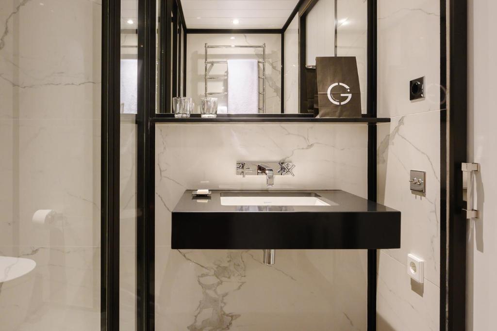 a bathroom with a sink and a mirror at Seventy Barcelona in Barcelona