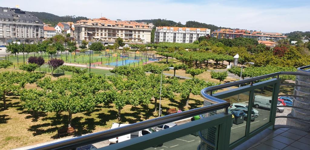 a view of a park with trees and buildings at Piso Portonovo Sanxenxo in Portonovo