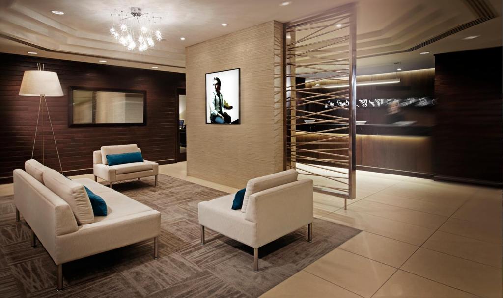 a lobby with two chairs and a wine cellar at Cambridge Suites Hotel Halifax in Halifax