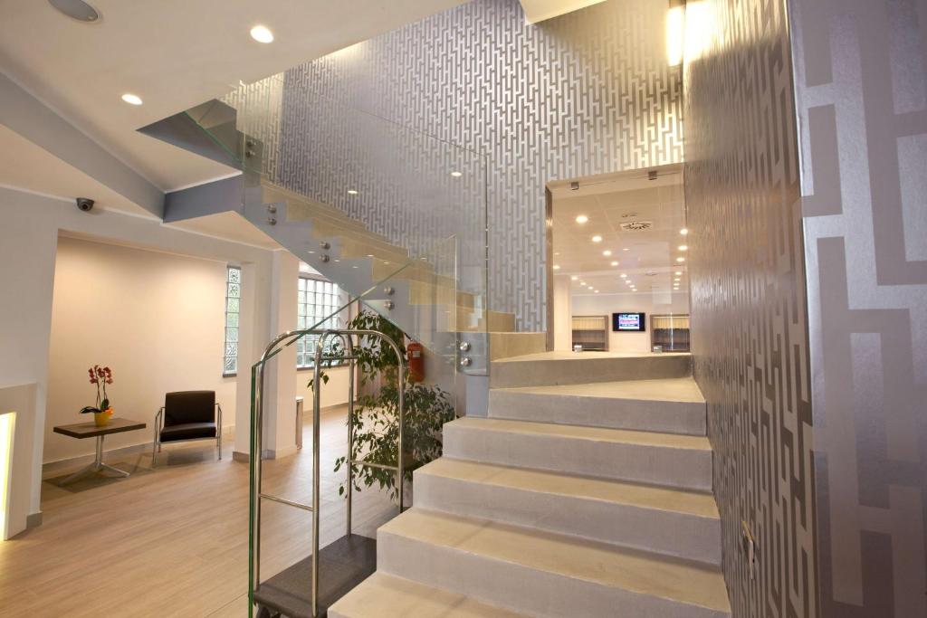 a staircase in a building with a lobby at Best Western Plus Borgolecco Hotel in Arcore