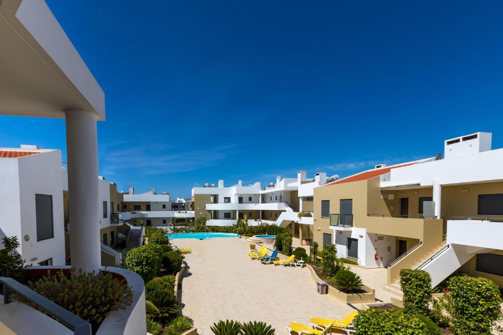 a view of the courtyard of a resort with a swimming pool at One Bedroom Apartment in Albur Village 2J in Alvor