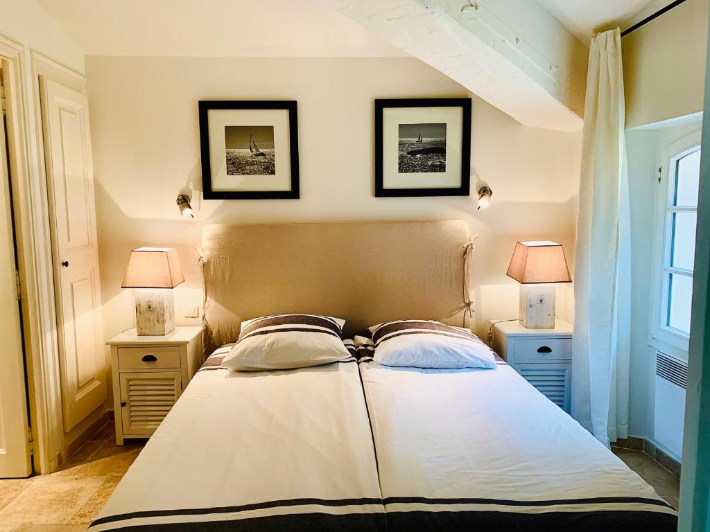 a bedroom with a bed with two lamps on it at Maison Saint-Tropez in Saint-Tropez