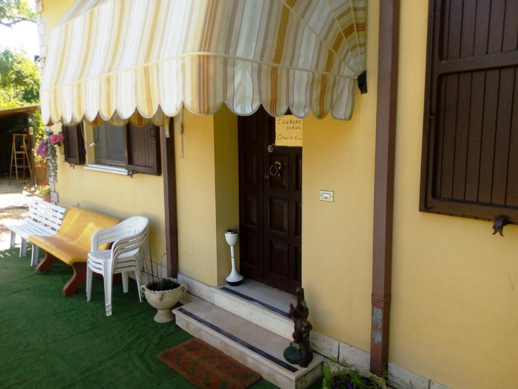 una casa con una mesa, sillas y una puerta en Casa di Igor, en Casemurate
