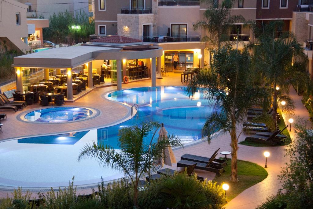 an aerial view of a hotel pool at night at Okeanis Golden Resort in Kato Daratso