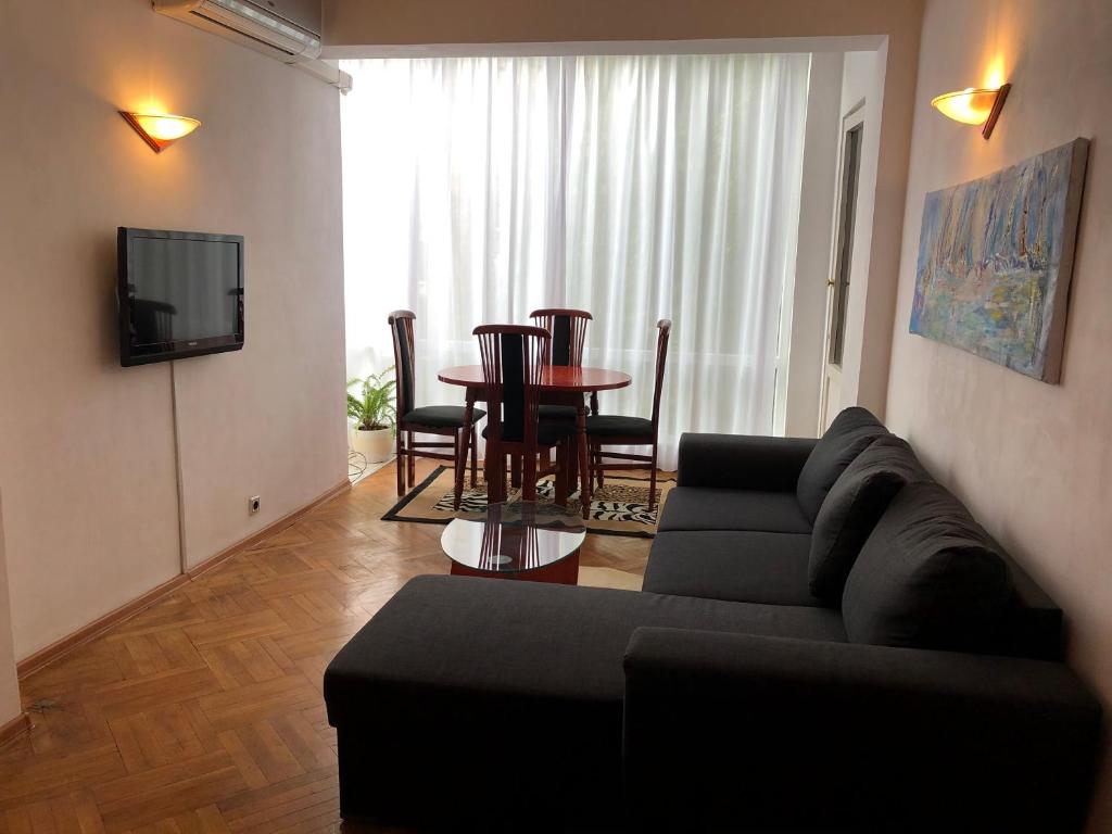 ein Wohnzimmer mit einem Sofa und einem Tisch in der Unterkunft Stelius I in Pomorie
