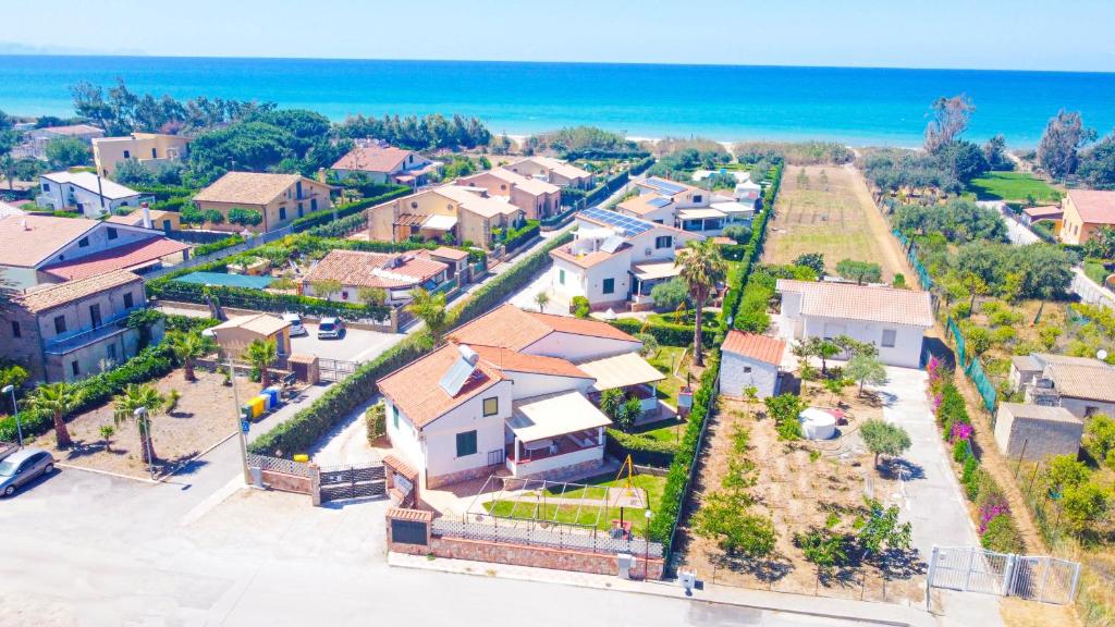 an aerial view of a house with the ocean at Case Vacanze Mare Nostrum - Villas in front of the Beach with Pool in Campofelice di Roccella
