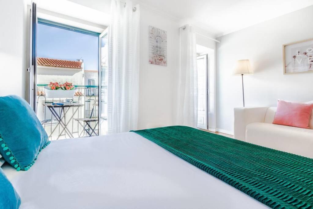 Ένα ή περισσότερα κρεβάτια σε δωμάτιο στο Alfama Best Balcony