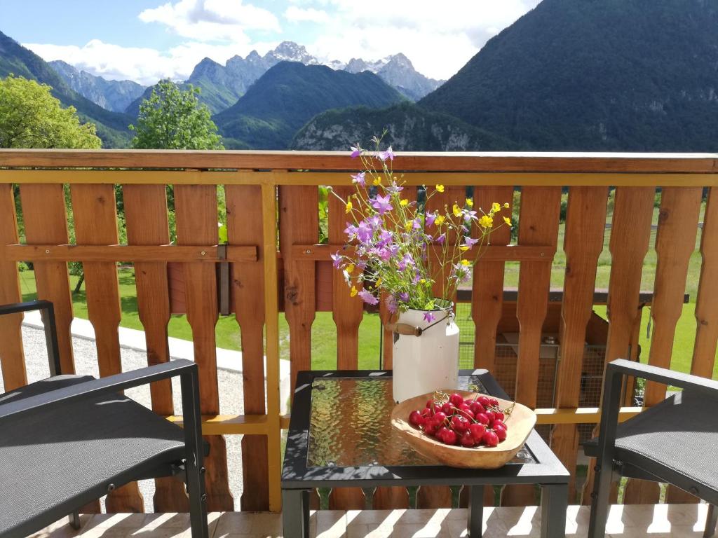 a table with a basket of fruit on a balcony at Apartments Mas in Dovje