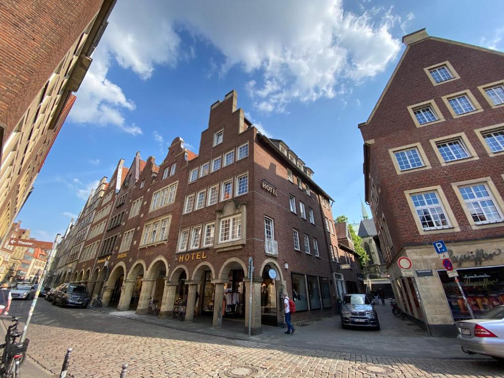 un gran edificio de ladrillo en una calle de la ciudad en Hotel Busche am Dom, en Münster