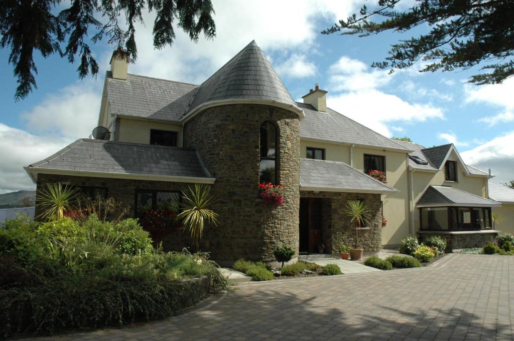 a large house with a tile roof at AbbeyCourt Kenmare Kerry in Kenmare