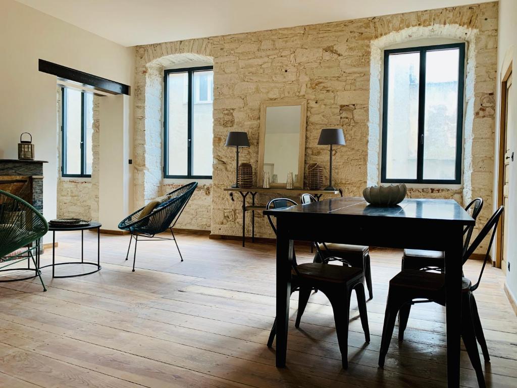 a living room with a dining room table and chairs at CASA CITADELLA Bonifacio in Bonifacio